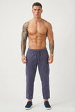 Men's cropped linen trousers in indigo by FJØRNA, featuring a relaxed fit and stylish design.