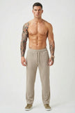 Men's relaxed knit trousers in khaki by FJØRNA, featuring a comfortable fit and casual style.