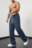 FJØRNA men's distressed black trousers with a relaxed fit, featuring ripped details and casual style.