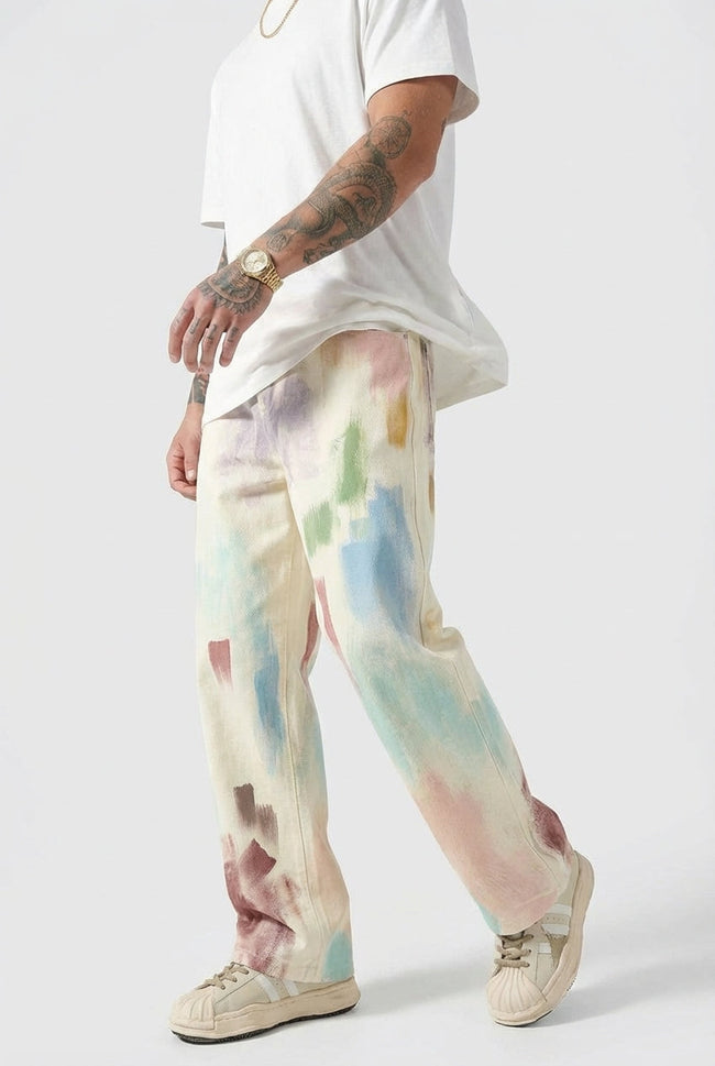 Men's black painted trousers by FJØRNA, slim fit pants with stylish design, shown on a model in a modern setting.