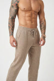 Men's beige merino wool trousers by FJØRNA, showcasing a tailored fit and soft wool fabric with front pockets.