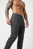 Men's Merino Wool Trousers in dark grey by FJØRNA, showing the stylish fit and soft fabric texture.