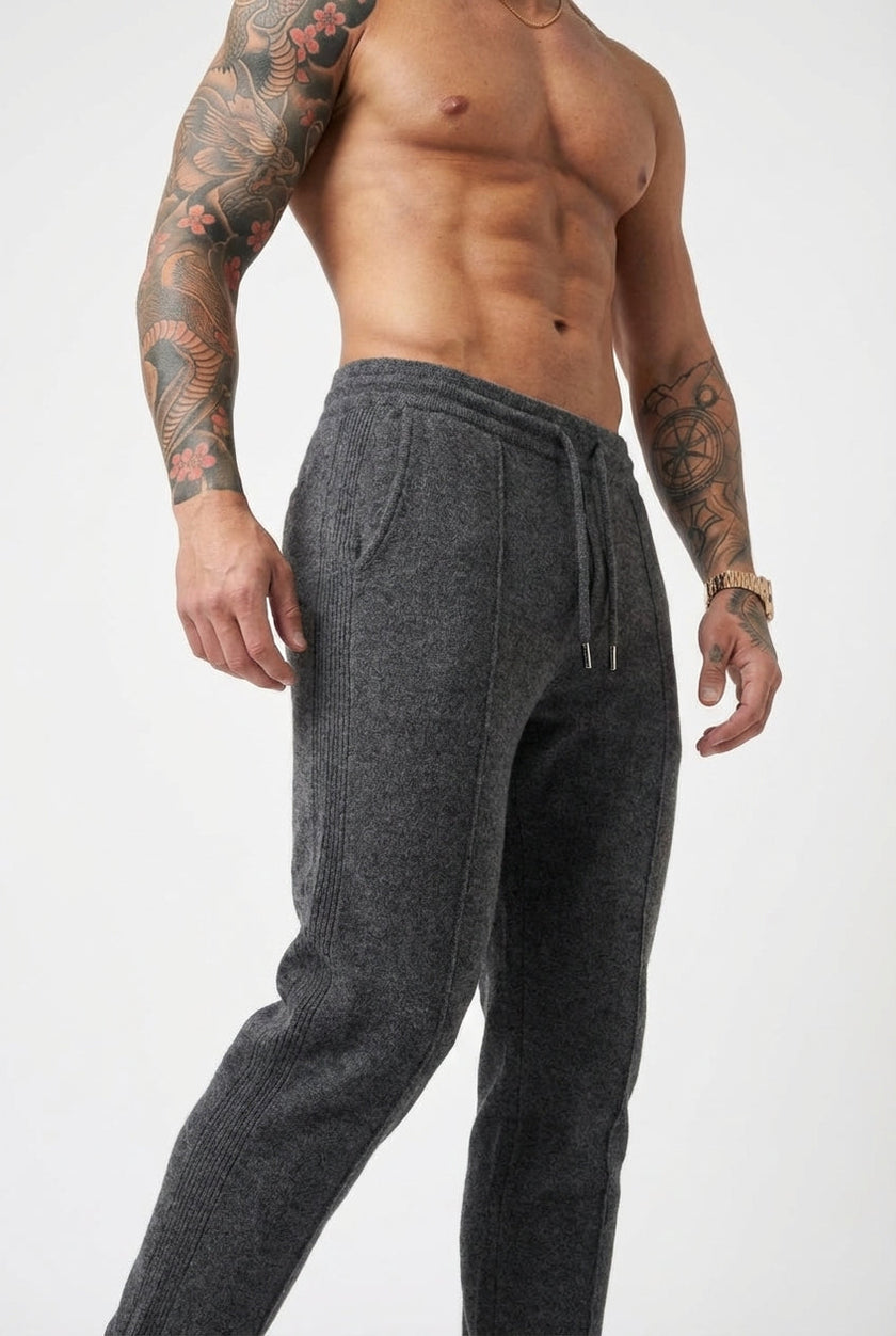 Men's Merino Wool Trousers in dark grey by FJØRNA, showing the stylish fit and soft fabric texture.
