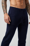 Men's navy Merino wool trousers by FJØRNA, stylish and comfortable pants for casual or formal wear, seen from front view.