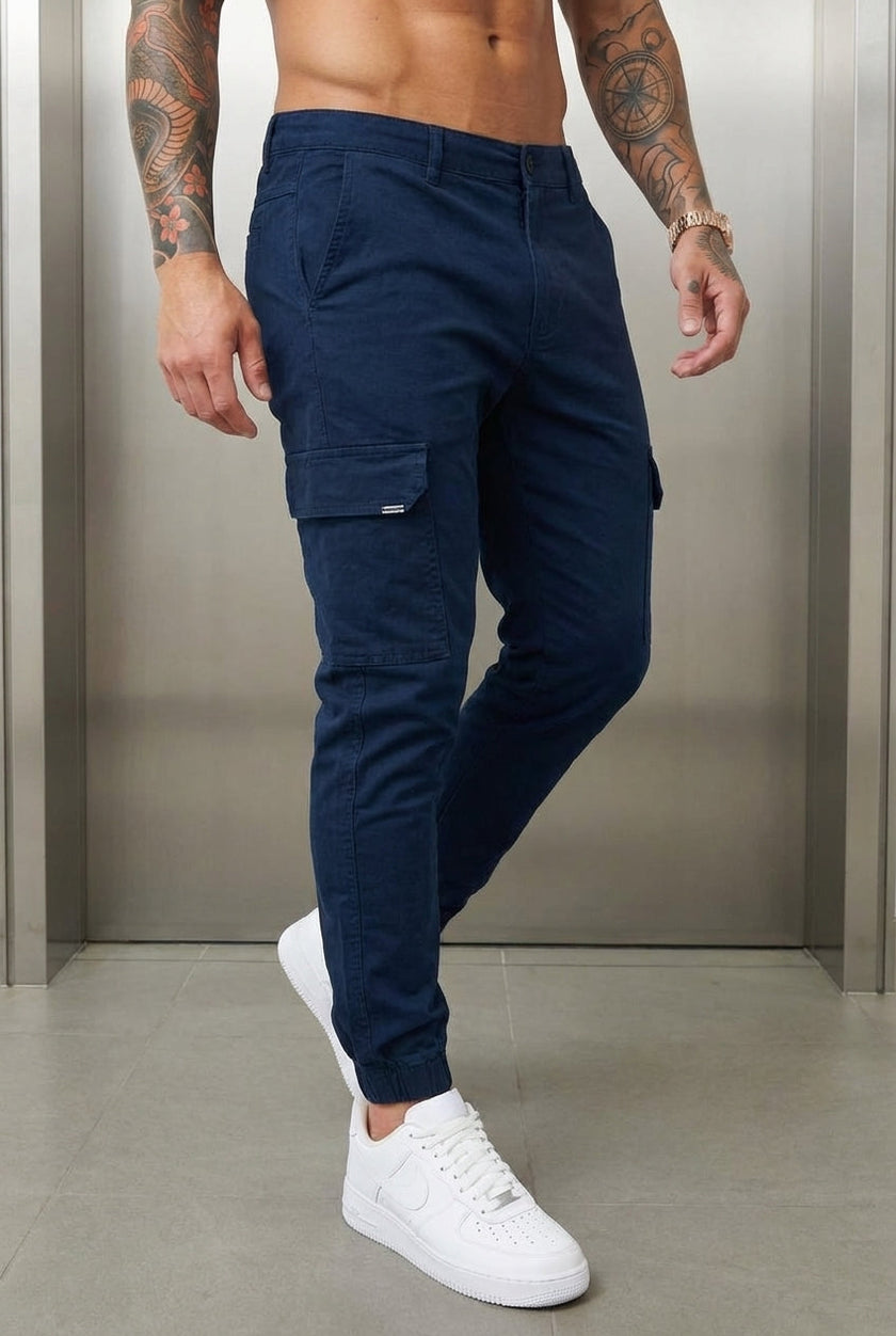 Men's navy cargo jogger trousers by FJØRNA featuring a relaxed fit and multiple utility pockets.