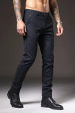 FJØRNA men's slim-fit blue trousers displayed on a model, showcasing modern tailored pants with a sleek fit.