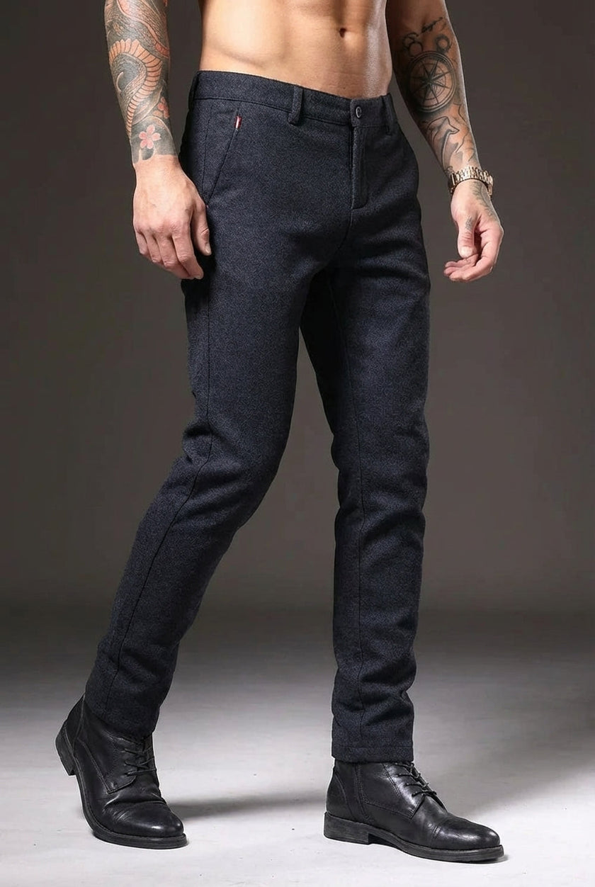 FJØRNA men's slim-fit blue trousers displayed on a model, showcasing modern tailored pants with a sleek fit.