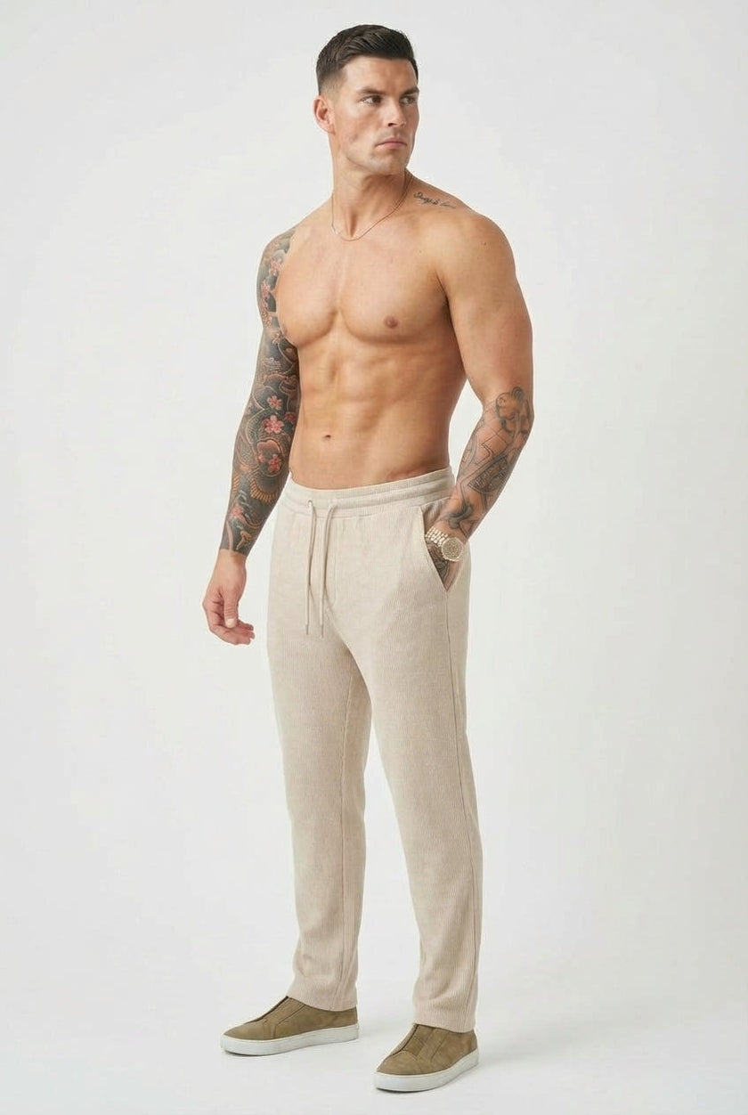 Men's relaxed knit trousers in khaki by FJØRNA, featuring a comfortable fit and soft knit fabric.
