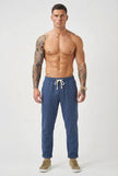 Men's linen tailored trousers by FJØRNA, showing a pair of stylish, beige linen pants with a tailored fit and classic design.