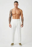 Men's white tailored trousers by FJØRNA, shown on a model, featuring a sleek fit and classic design.