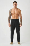Men's black tailored trousers by FJØRNA, featuring a slim fit and modern design, shown on a model.
