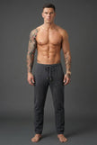 Men's dark grey merino wool trousers by FJØRNA, tailored fit, showcasing the fabric texture and stylish design.
