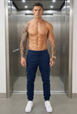 Men's navy cargo jogger trousers by FJØRNA, showing relaxed fit, multiple pockets, and comfortable waistband.