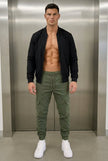 Men's cargo jogger trousers in army green by FJØRNA, featuring a relaxed fit and multiple utility pockets.