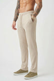 Men's relaxed knit trousers in khaki by FJØRNA, featuring a comfortable fit and casual style, shown on a model.