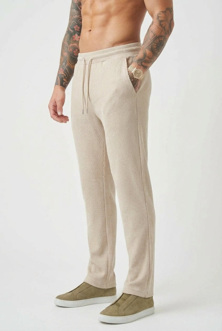 Men's relaxed knit trousers in khaki by FJØRNA, featuring a comfortable fit and casual style, shown on a model.