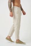 Men's cropped linen trousers in indigo by FJØRNA, showcasing relaxed fit and lightweight fabric for casual style.