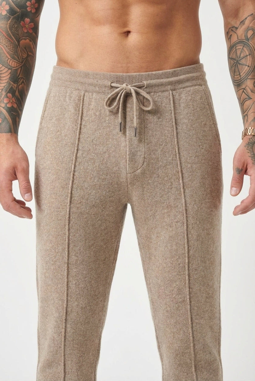 Men's beige merino wool trousers by FJØRNA, showing a close-up of stylish, comfortable wool pants with a tailored fit.