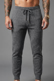 Men's Merino Wool Trousers in dark grey by FJØRNA, showing a close-up of the stylish, comfortable pants fabric and fit.