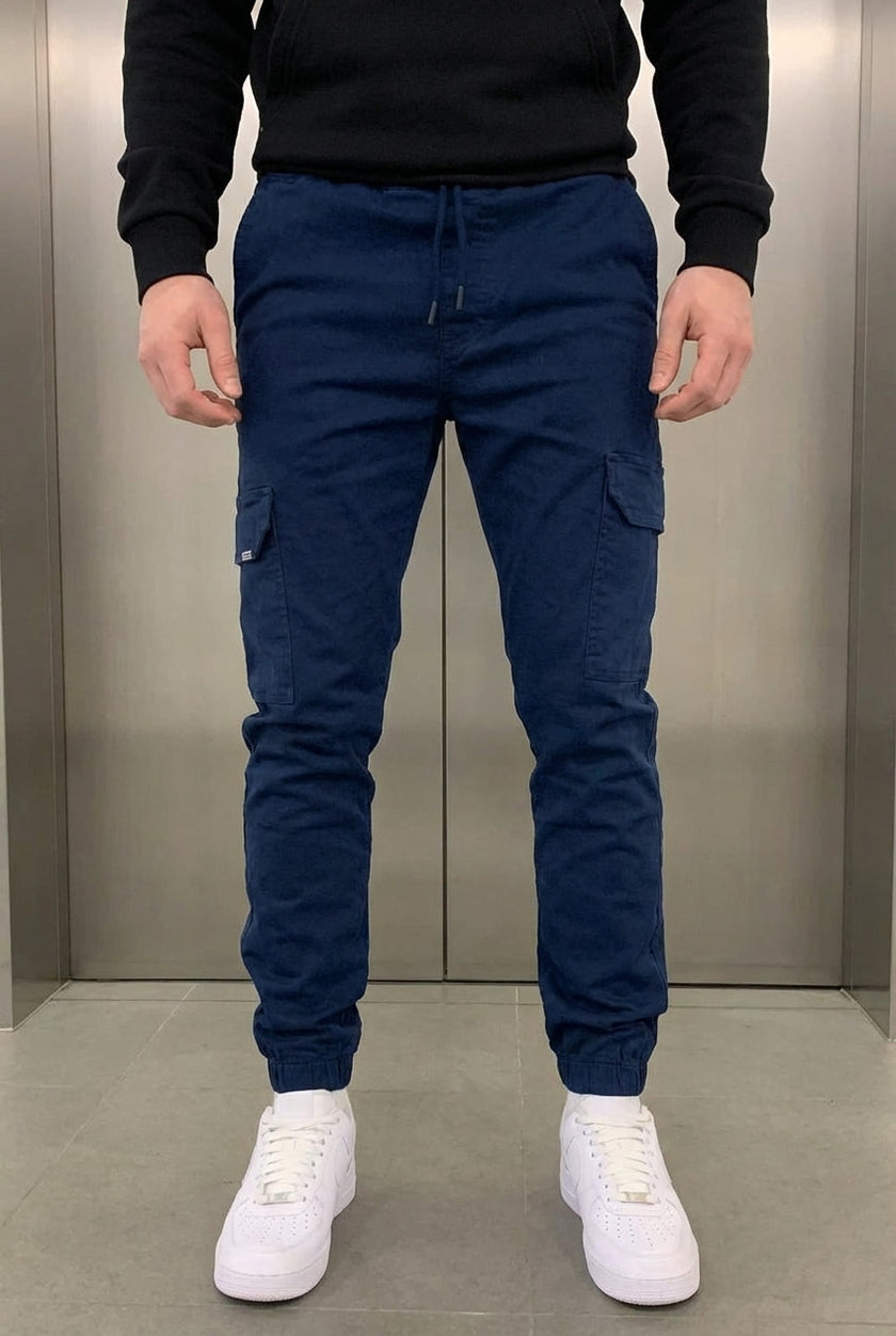 Men's navy cargo jogger trousers by FJØRNA, featuring relaxed fit, multiple pockets, and comfortable fabric for casual wear.