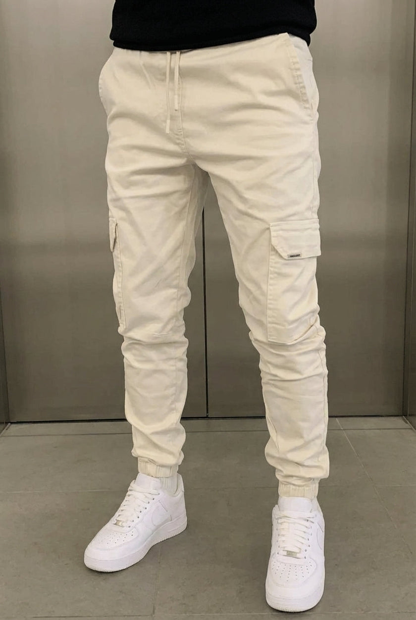 Men's cargo jogger trousers in cream by FJØRNA, featuring relaxed fit, multiple pockets, and casual style.
