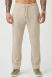 Men's relaxed fit knit trousers in khaki by FJØRNA, featuring a comfortable waistband and casual style.