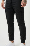 Men's black cargo jogger trousers by FJØRNA, featuring multiple pockets and a relaxed fit, shown on a model.