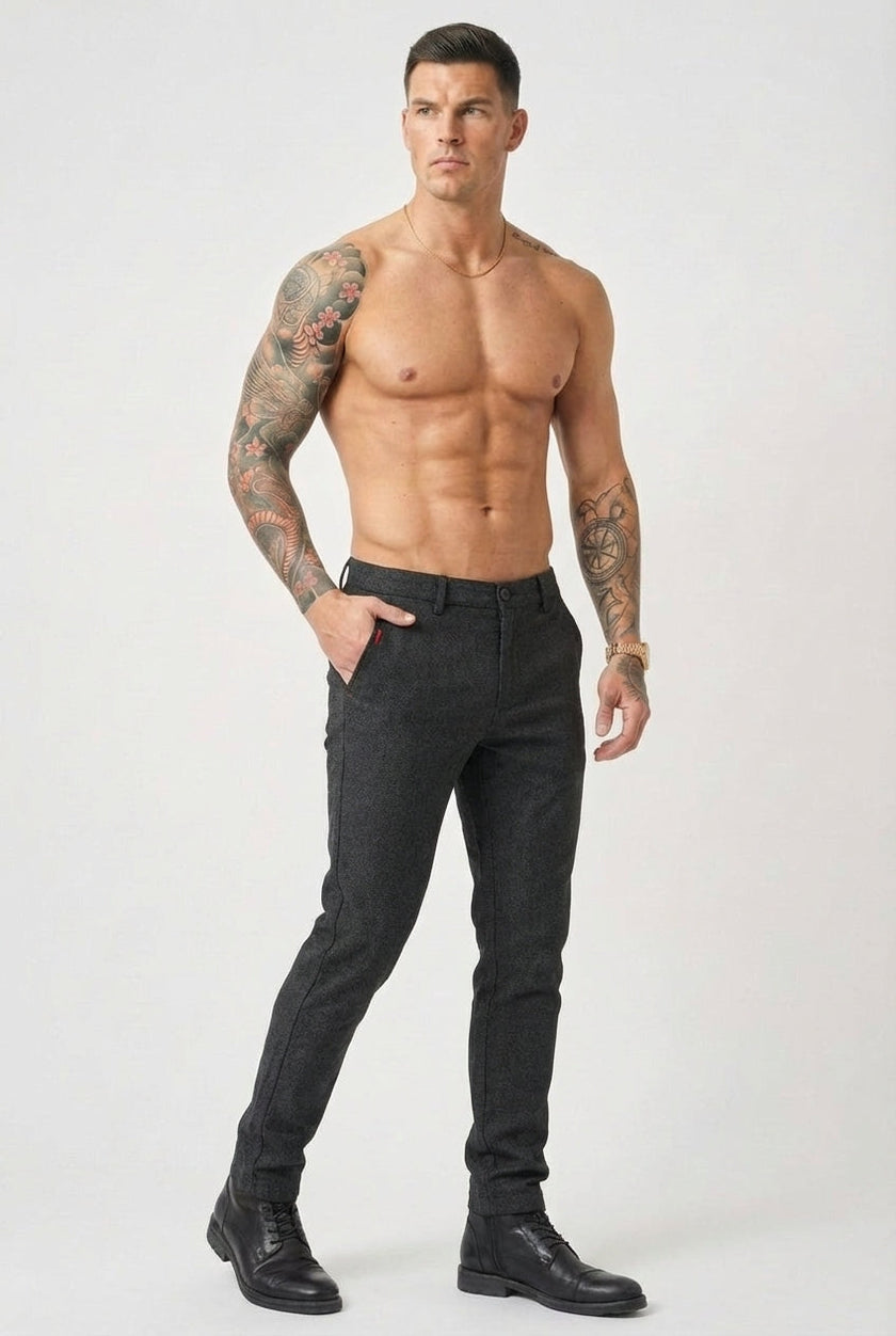 Men's slim-fit black trousers by FJØRNA, featuring a tailored design and smooth fabric, shown on a model.