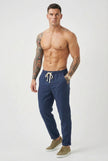 Men's linen tailored trousers by FJØRNA, featuring a sleek fit and natural fabric in a versatile neutral color.
