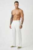 Men's tailored white trousers by FJØRNA, featuring a slim fit and classic design, shown on a male model.