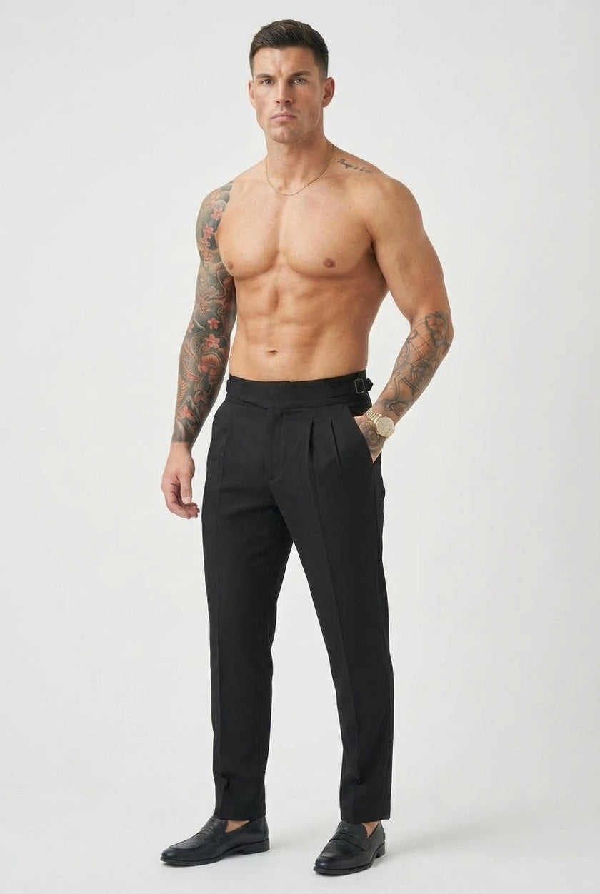 Black tailored men's trousers by FJØRNA, featuring a sleek fit and classic design, shown on a model.