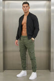 Men's cargo jogger trousers in army green by FJØRNA, featuring a relaxed fit with multiple cargo pockets and elastic cuffs.