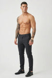 FJØRNA slim-fit men's blue trousers displayed on a hanger, showcasing the tailored design and fabric details.