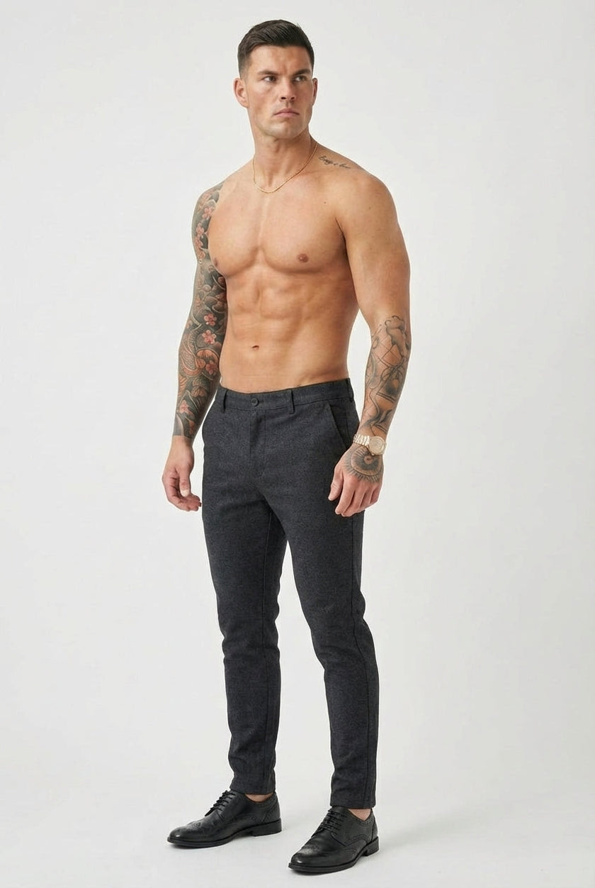 FJØRNA slim-fit men's blue trousers displayed on a hanger, showcasing the tailored design and fabric details.