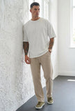 Men's relaxed knit trousers in khaki by FJØRNA, shown in a casual fit with soft knit fabric and a comfortable waistband.