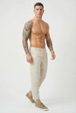 Men's cropped linen trousers in indigo by FJØRNA, featuring a relaxed fit and lightweight fabric for casual summer style.