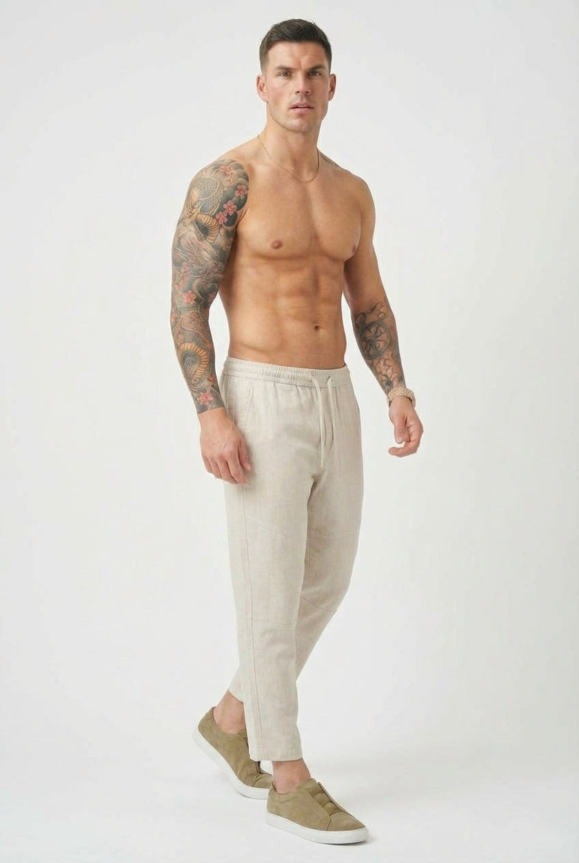 Men's cropped linen trousers in indigo by FJØRNA, featuring a relaxed fit and lightweight fabric for casual summer style.