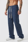 Black distressed men's trousers by FJØRNA, showcasing a casual fit with ripped details and rugged style.