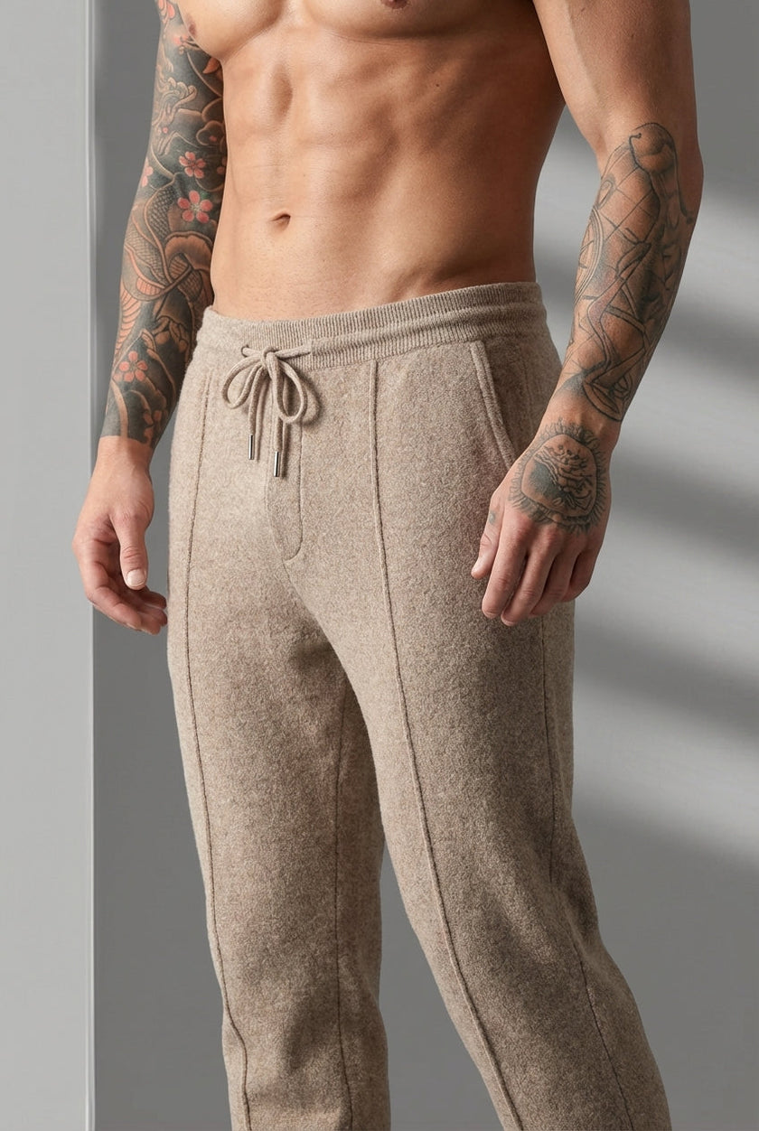 Men's beige merino wool trousers by FJØRNA, showcasing a tailored fit and soft textured fabric.