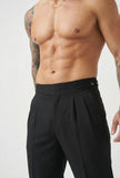 Men's tailored black trousers by FJØRNA, showcasing a sleek fit and classic design in a professional studio setting.
