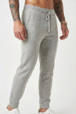 FJØRNA men's merino wool trousers in light grey, showcasing a tailored fit and soft, comfortable fabric.