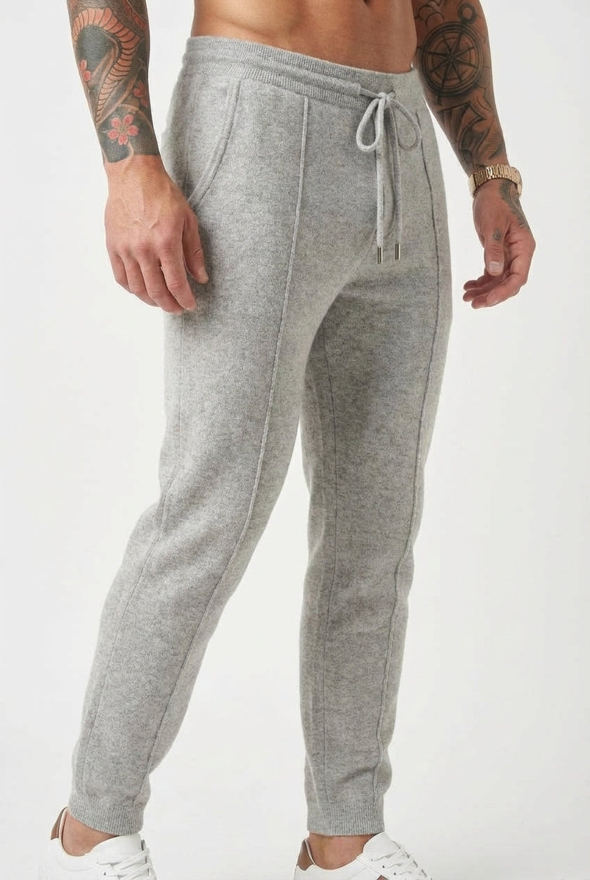 FJØRNA men's merino wool trousers in light grey, showcasing a tailored fit and soft, comfortable fabric.