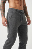 Men's dark grey Merino wool trousers by FJØRNA, stylish and comfortable pants shown on a model.