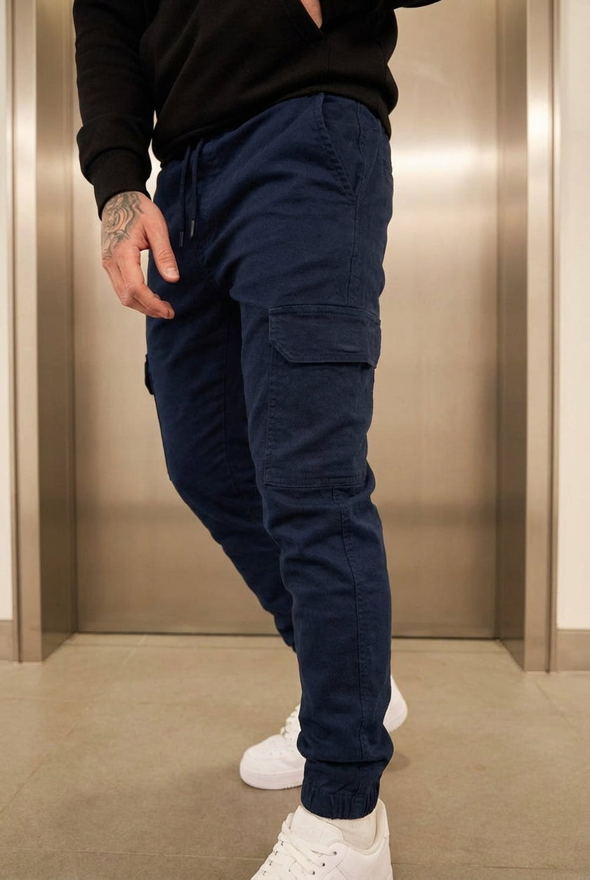 Men's navy cargo jogger trousers by FJØRNA, featuring relaxed fit and practical pockets, ideal for casual and active wear.