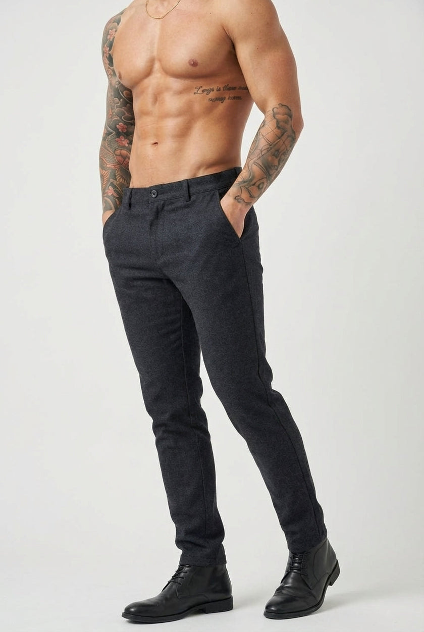 Slim-fit men's blue trousers by FJØRNA, featuring a tailored design and classic style, shown on a model.