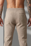 Men's beige Merino wool trousers by FJØRNA, stylish and comfortable pants with a tailored fit, shown on a model.