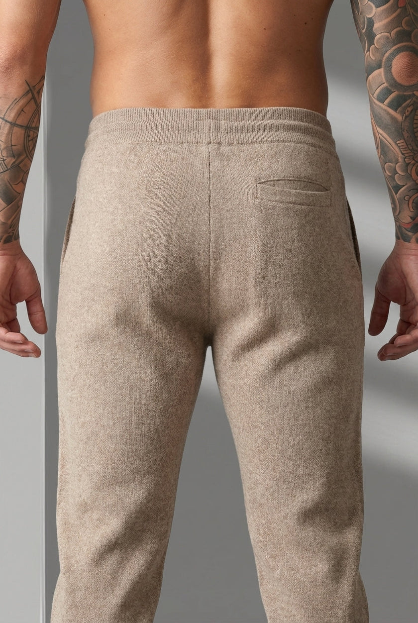 Men's beige Merino wool trousers by FJØRNA, stylish and comfortable pants with a tailored fit, shown on a model.