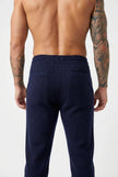 Men's navy Merino wool trousers by FJØRNA, showcasing a tailored fit and smooth fabric in a stylish design.