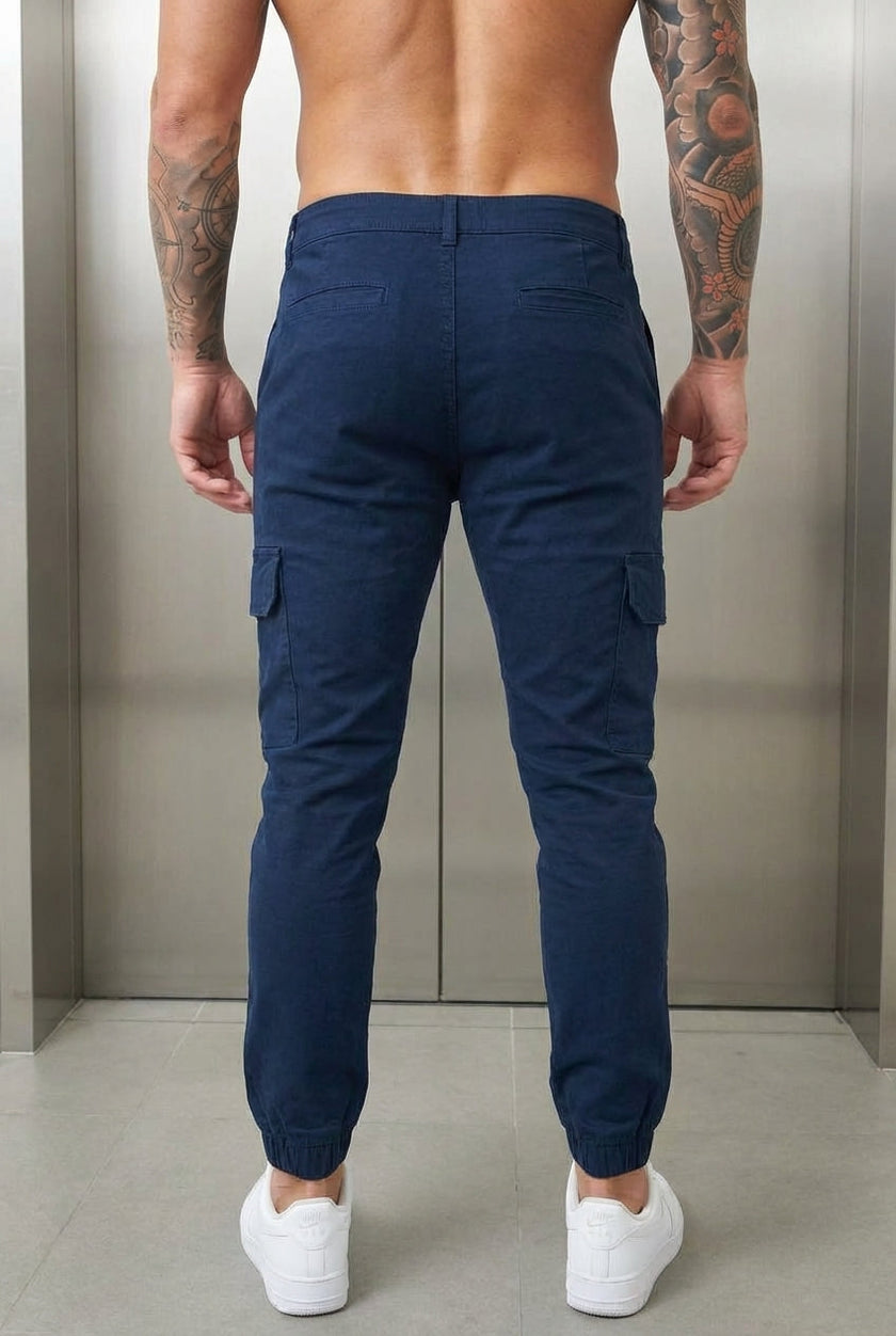 Men's navy cargo jogger trousers by FJØRNA, featuring a relaxed fit and multiple utility pockets, shown on a model.