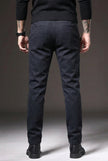 Men's slim-fit blue trousers by FJØRNA, tailored fit with modern style, shown on a male model in a casual setting